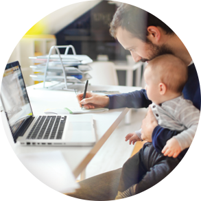 man at computer with infant